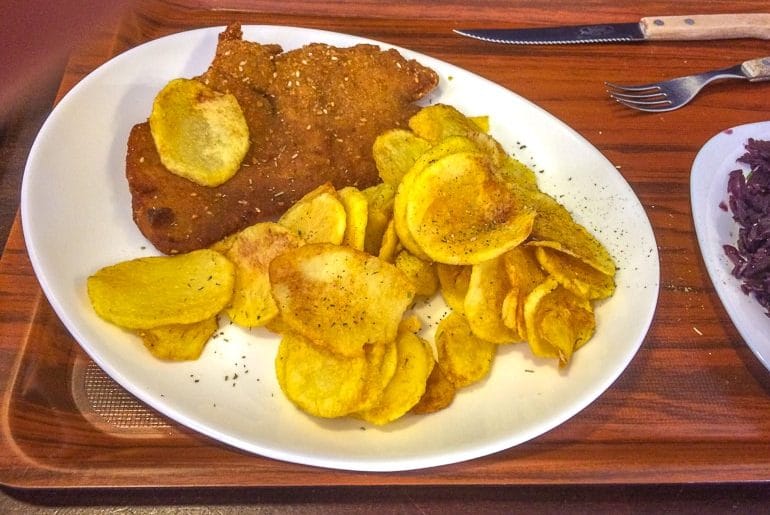 schnitzel and potatoes on white platter with cutlery 3 days in budapest