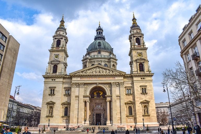 stone church with domes and towers in budapest square