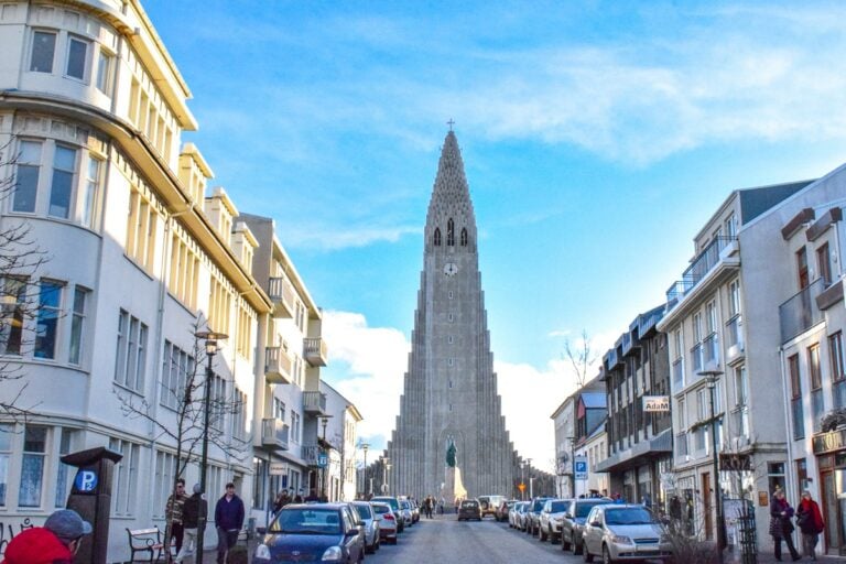 tall church tower with buildings beside in city centre reykjavik