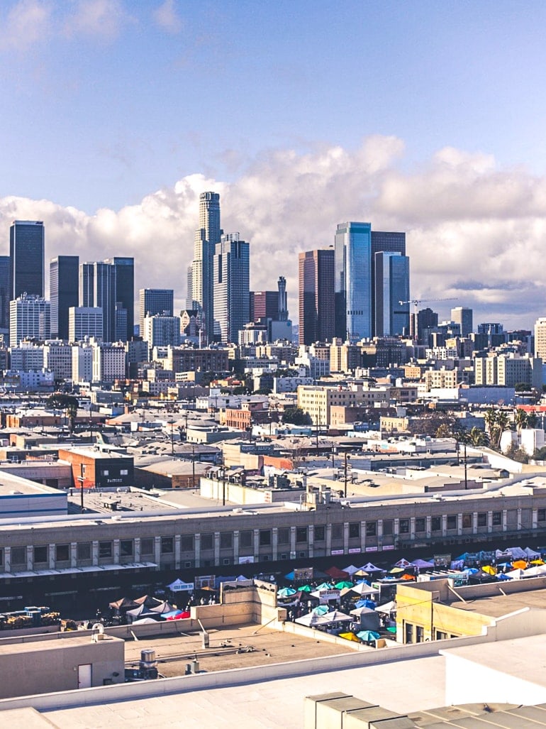 open air market with skyscrapers behind best places to visit in los angeles