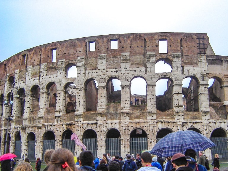 roman Colosseum in day time with people in front italy attractions 