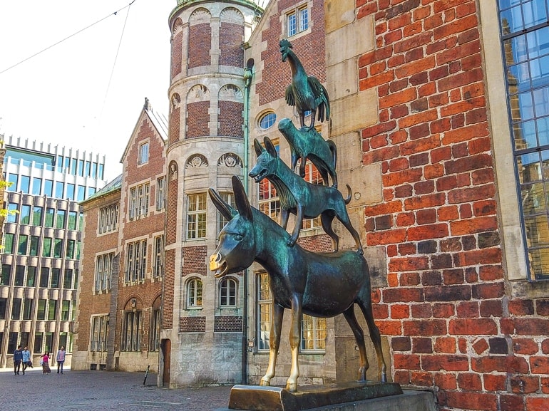 statue of animals on top of one another in old town bremen germany