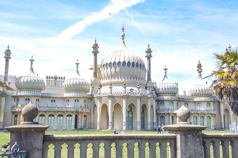 white palace with towers and green grass in front brighton