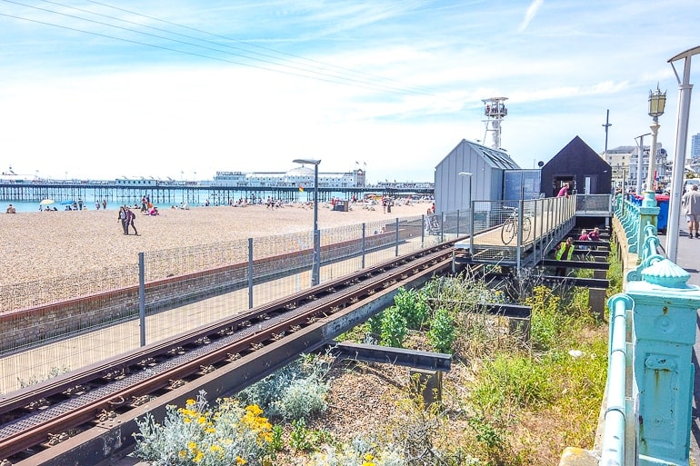 railway track along the beach front with fences on both sides.
