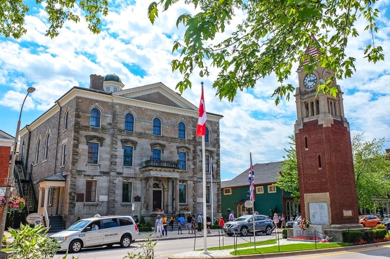 old town hall with brick cenotaph and cars on the street niagara on the lake accommodations