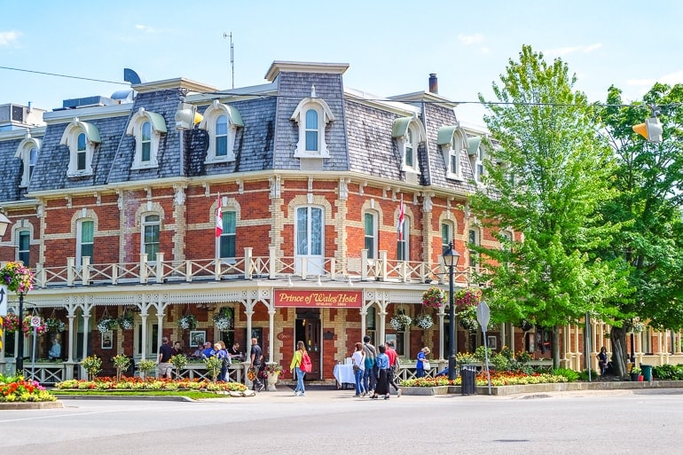 old hotel on street corner with red brick and gardens in niagara on the lake.