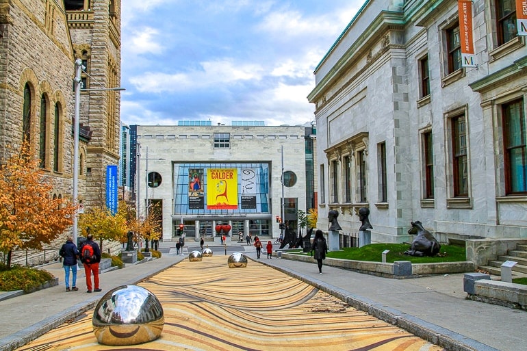 museum entrance with shiny spheres in front along sidewalk in montreal.