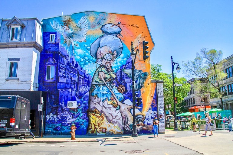 colourful blue wall mural on street corner in montreal.