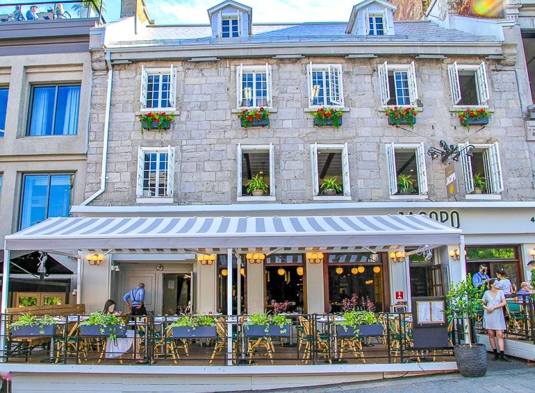 old limestone building with awning over restaurant in old montreal.