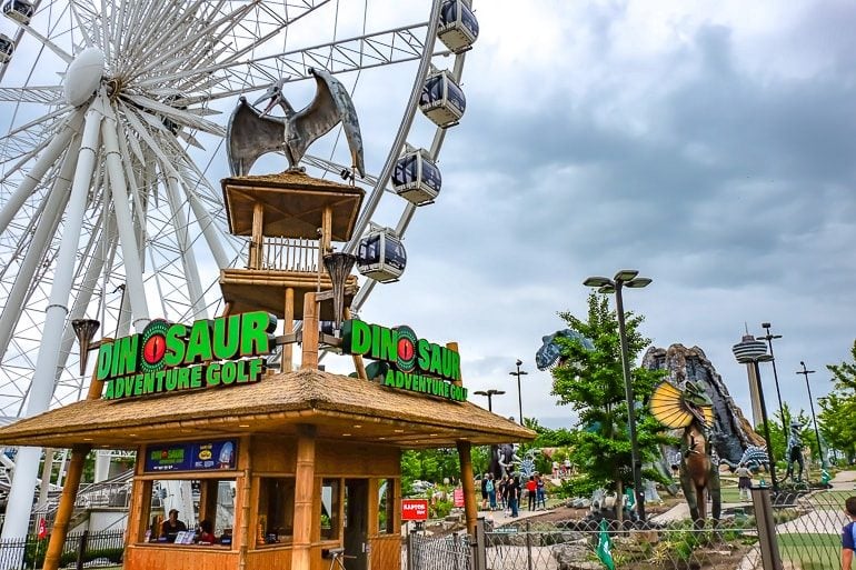 dinosaur on top of wooden hut with ferris wheel behind things to do niagara falls canada