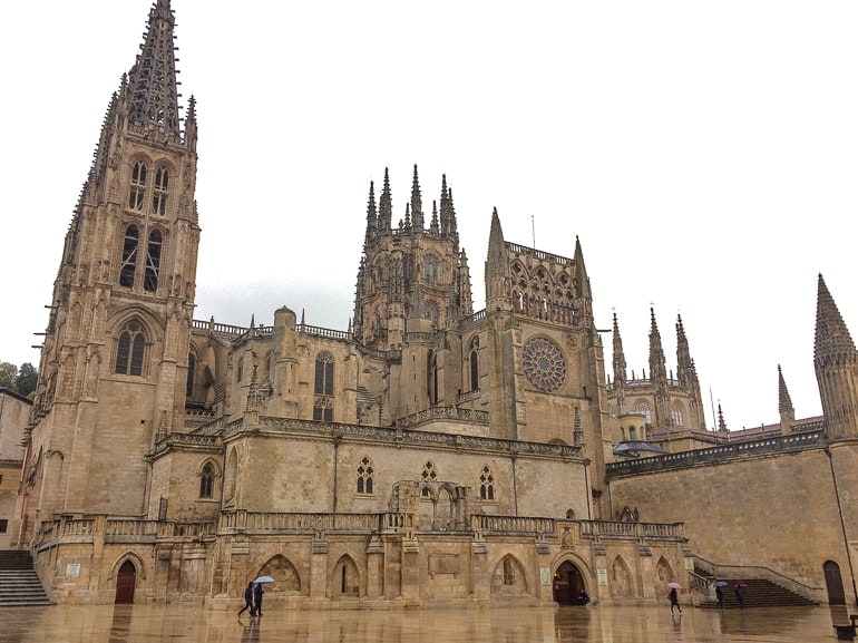 stone cathedral building in rain with reflective ground on front burgos beautiful cities spain