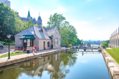 girl standing at edge of water in rideau canal lock one day in ottawa