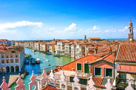 orange roofs and blue canal form above Fondaco dei Tedeschi terrace one day in venice italy
