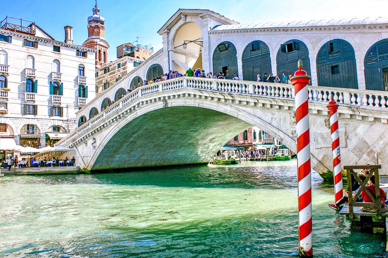 white decorated rialto bridge over blue canal Venice italy one day