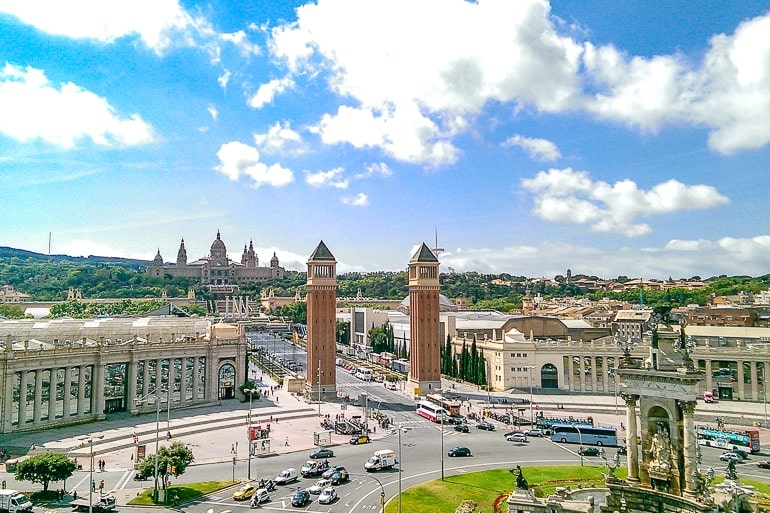 red towers near large roundabout with palace behind in barcelona spain itinerary