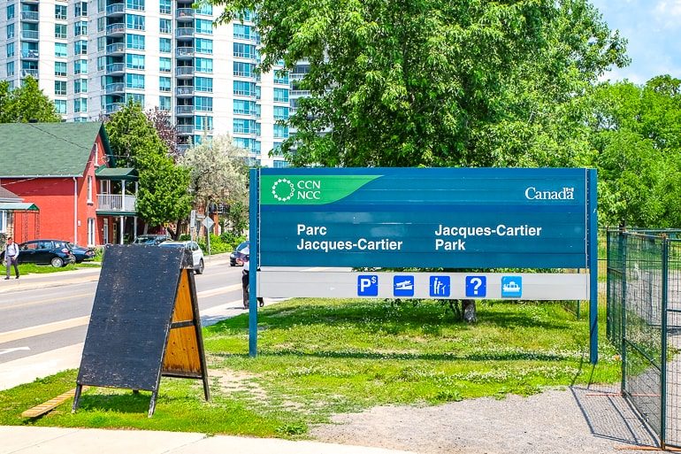 blue and green park sign on green grass jacques cartier park things to do ottawa canada