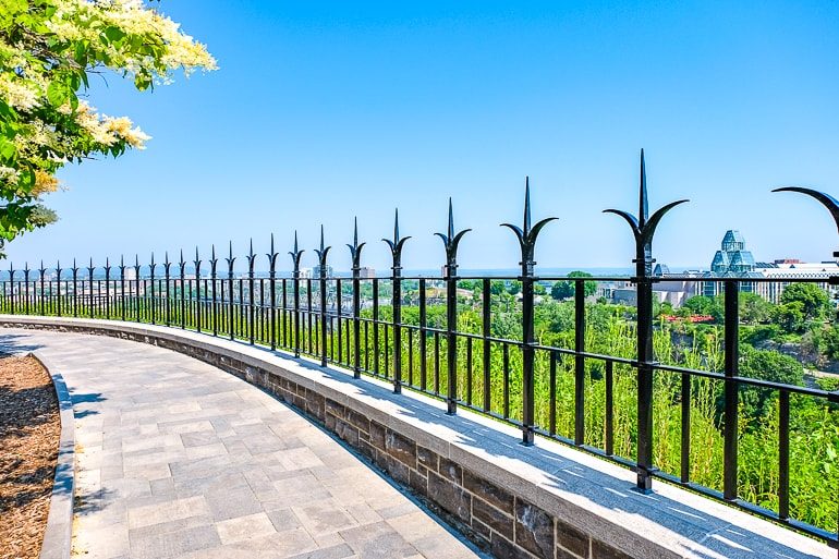 iron fence with stone pathway in front and views behind ottawa river canada