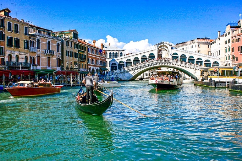 bridge over canal with boats in front rialto bridge things to do in venice