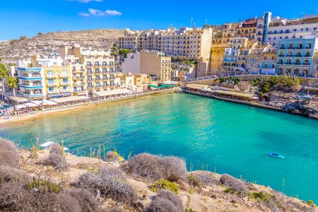 blue bay with hotels and cliffs surrounding gozo accommodations xlendi