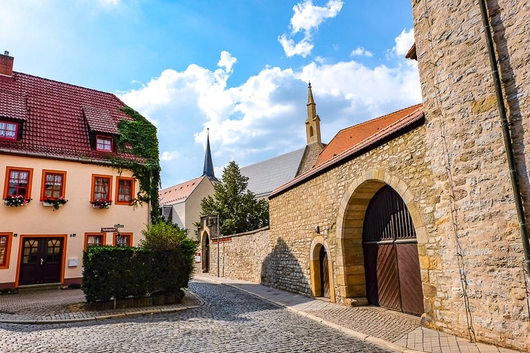 large stone wall with gate and building behind in erfurt germany old town