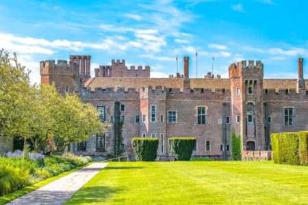 red brick herstmonceux castle with green gardens day trips from london