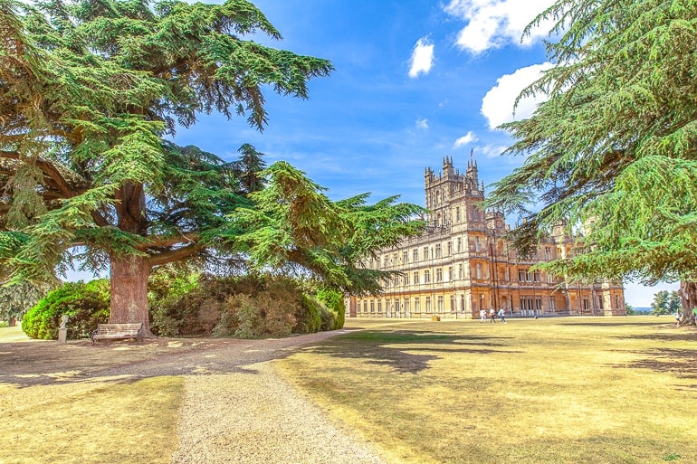 tall castle tower with trees in front downton abbey