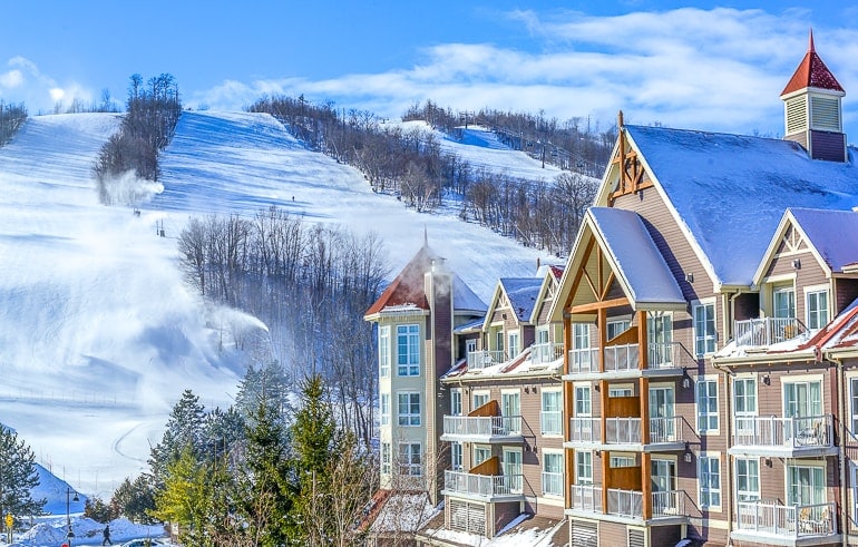chalet with snowy ski runs behind blue mountain collingwood