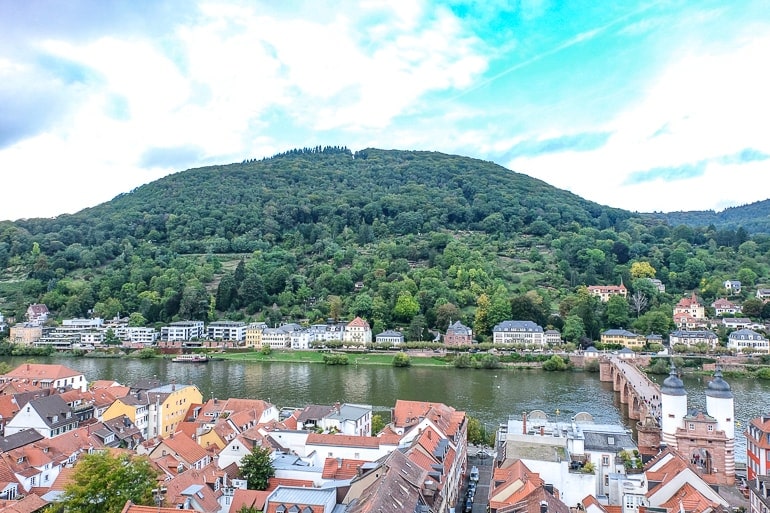 green hill with houses and river at the base in heidelberg germany
