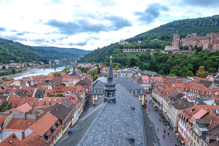 church roof with small tower overlooking roofs of german old town heidelberg germany