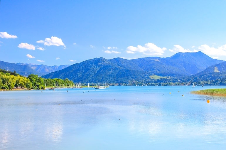 blue lake with mountains in background in germany.