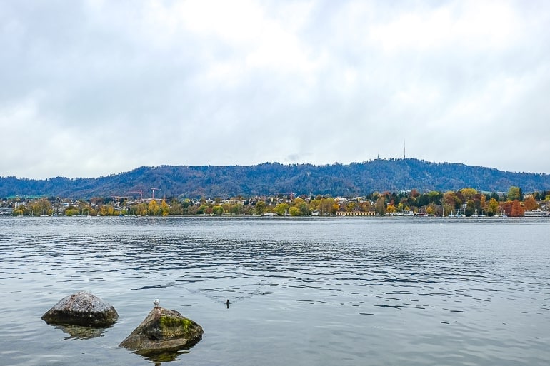large mountain in distance with lake in front in zurich