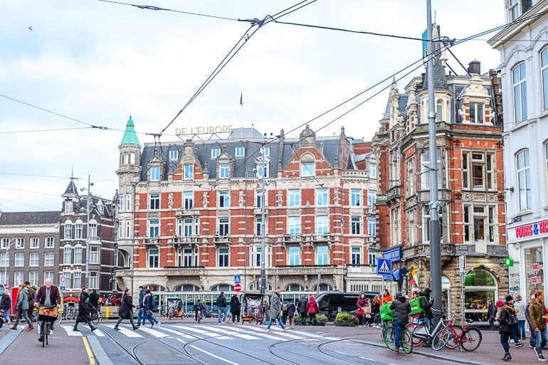 red brick luxury hotel in busy city centre amsterdam