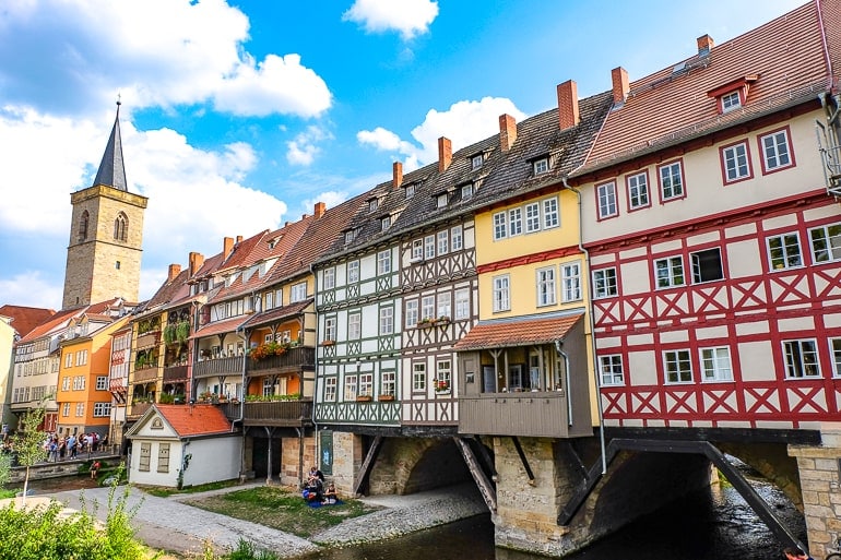 Bunte alte Fachwerkhäuser auf Brücke mit Fluss darunter in Erfurt Deutschland