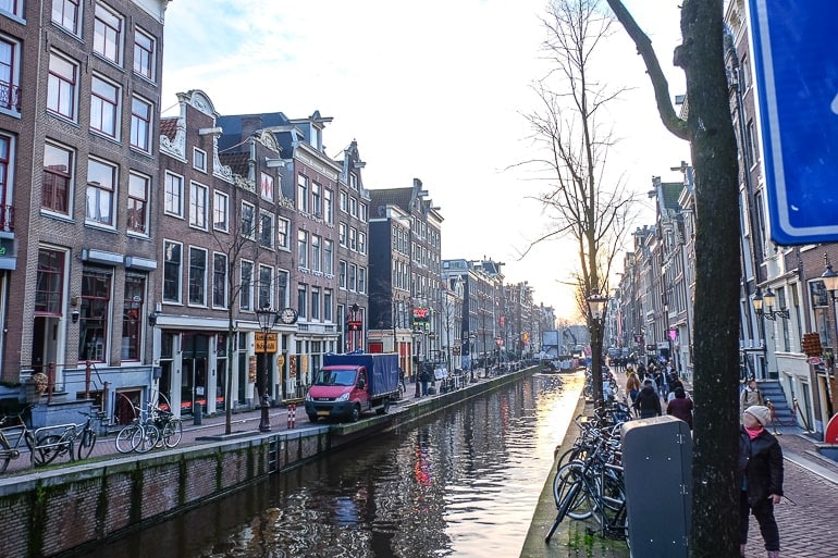 city canal in red light district with setting sun behind.