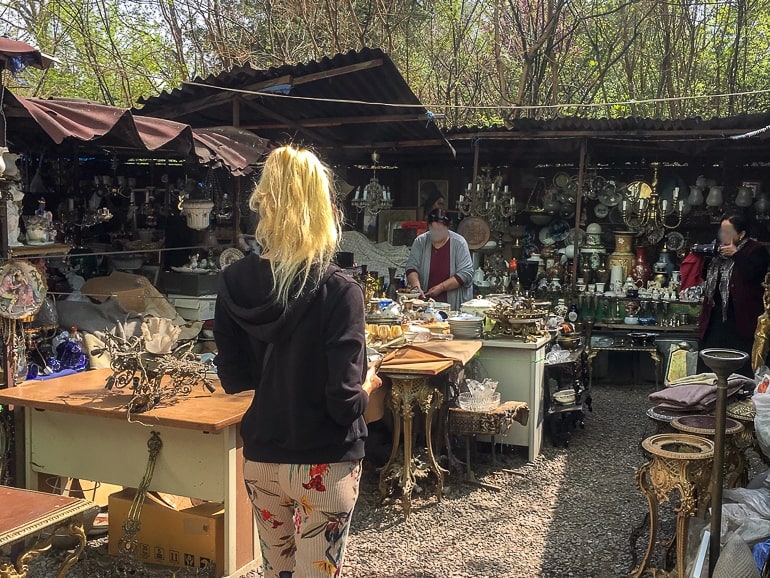 woman walking through open air market with stuff to be sold in tbilisi
