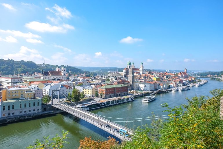 blue river with bridge over and old town behind things to do in passau germany