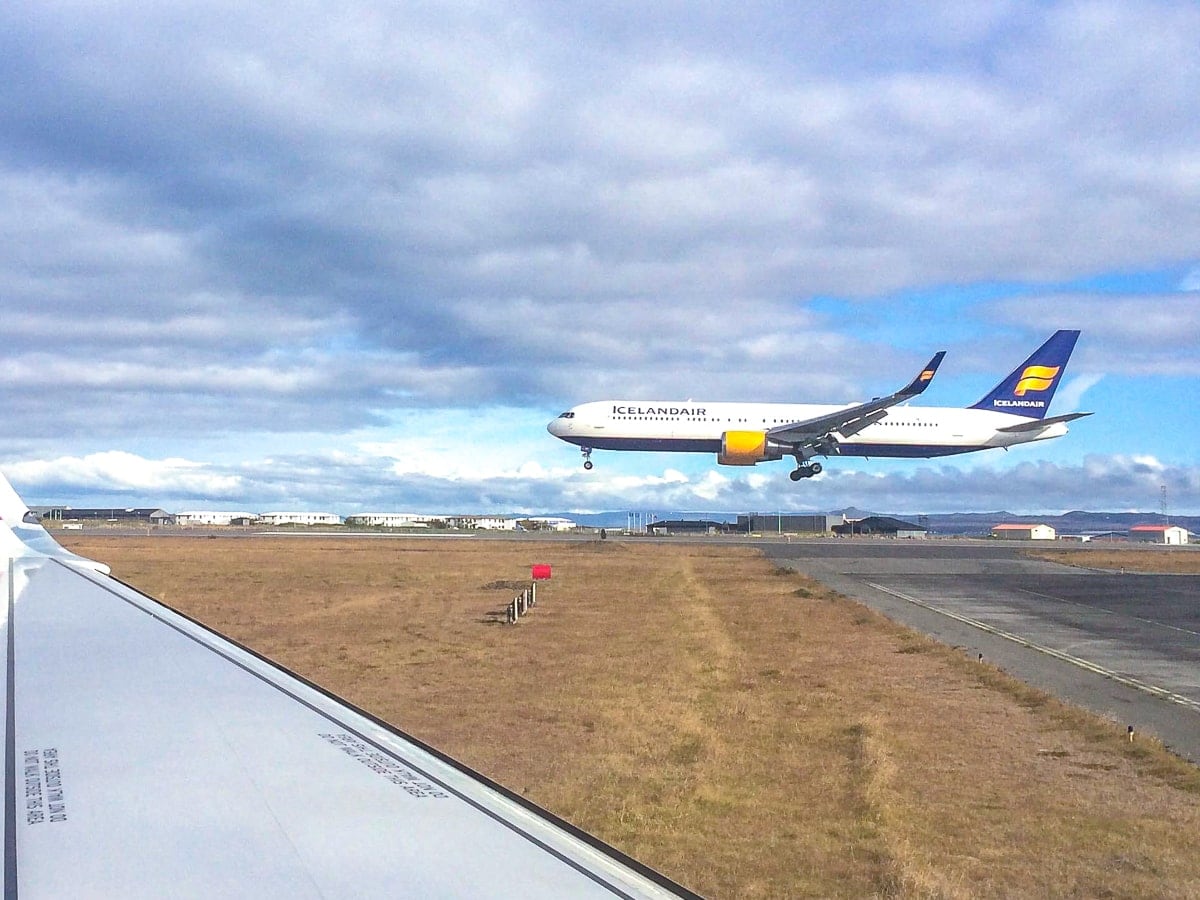 airplane landing with plane wing in front keflavik airport to reykjavik
