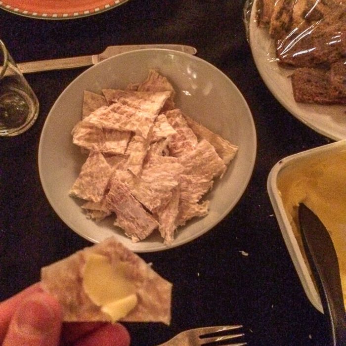 Schüssel mit isländischem getrockneten Fisch und Butter daneben auf einem Tisch