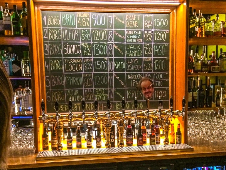 beer taps with chalkboard behind in bar in reykjavik
