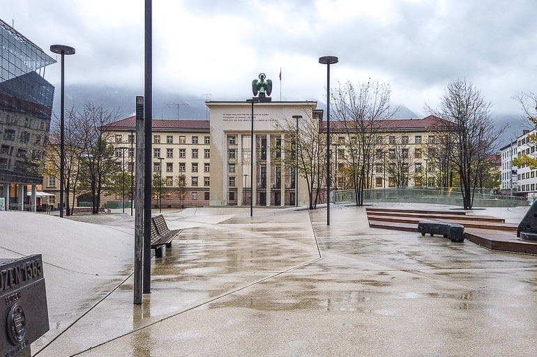 large open square with archway in middle of buildings in innsbruck