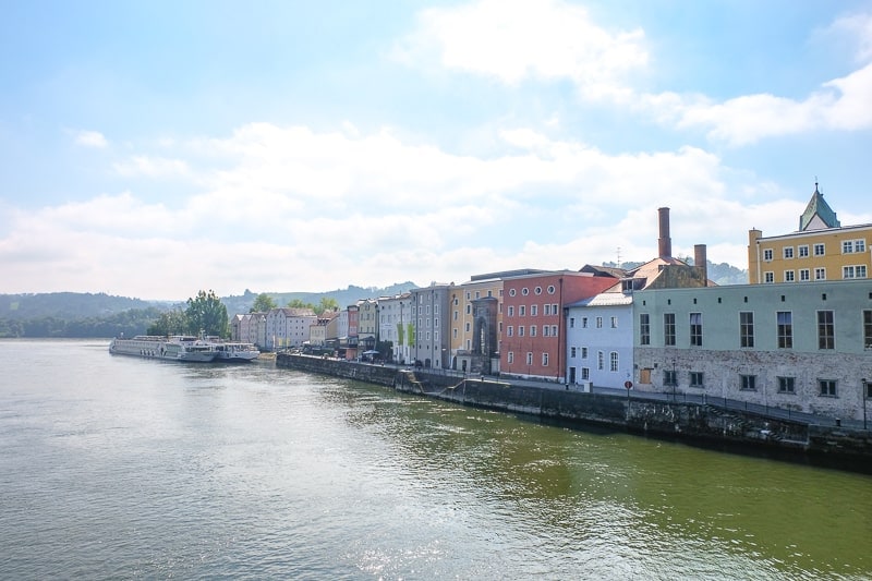 line of old colourful buildings by river in passau germany old town
