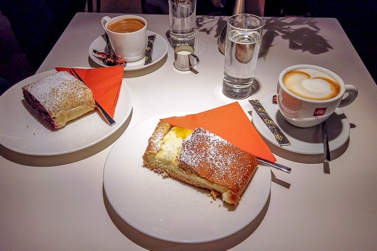 strudels on white plates with coffee on white table in innsbruck cafe