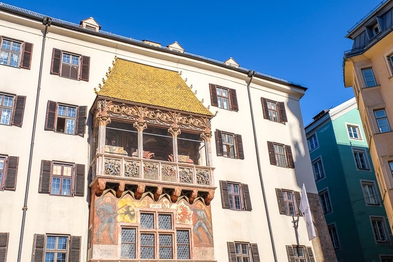 golden roof over balcony on white old building in innsbruck old town