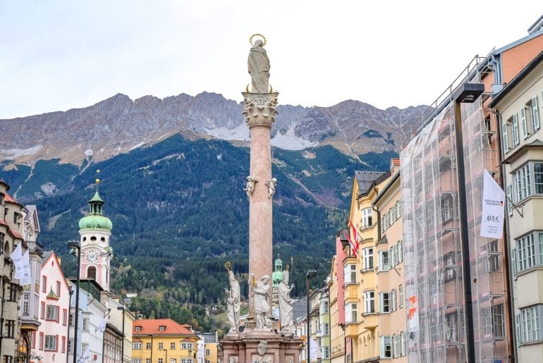 stone column in old town with mountains behind one day in innsbruck