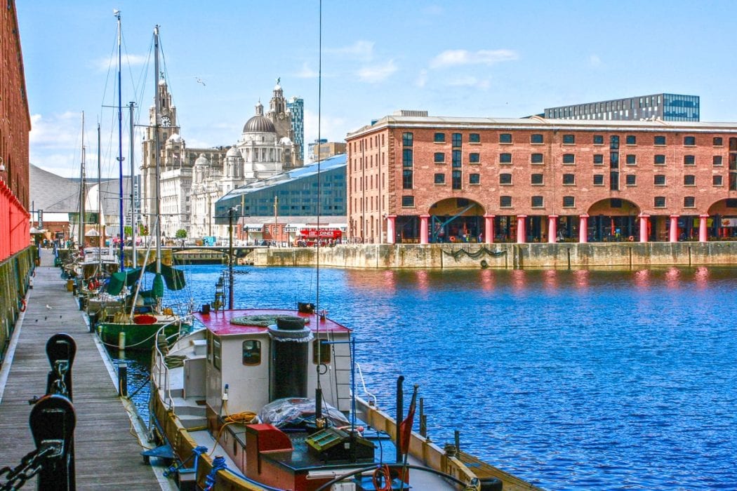 red brick pier building with boat in water things to do in liverpool