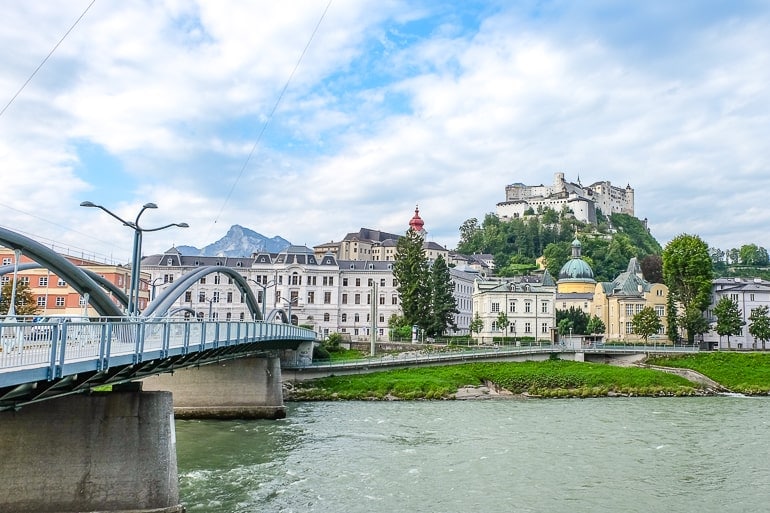 castle on hill with river below and bridge on left in salzburg