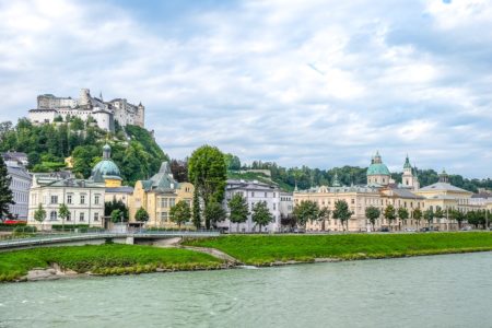castle on hill with old town and river below thing to do in salzburg austria