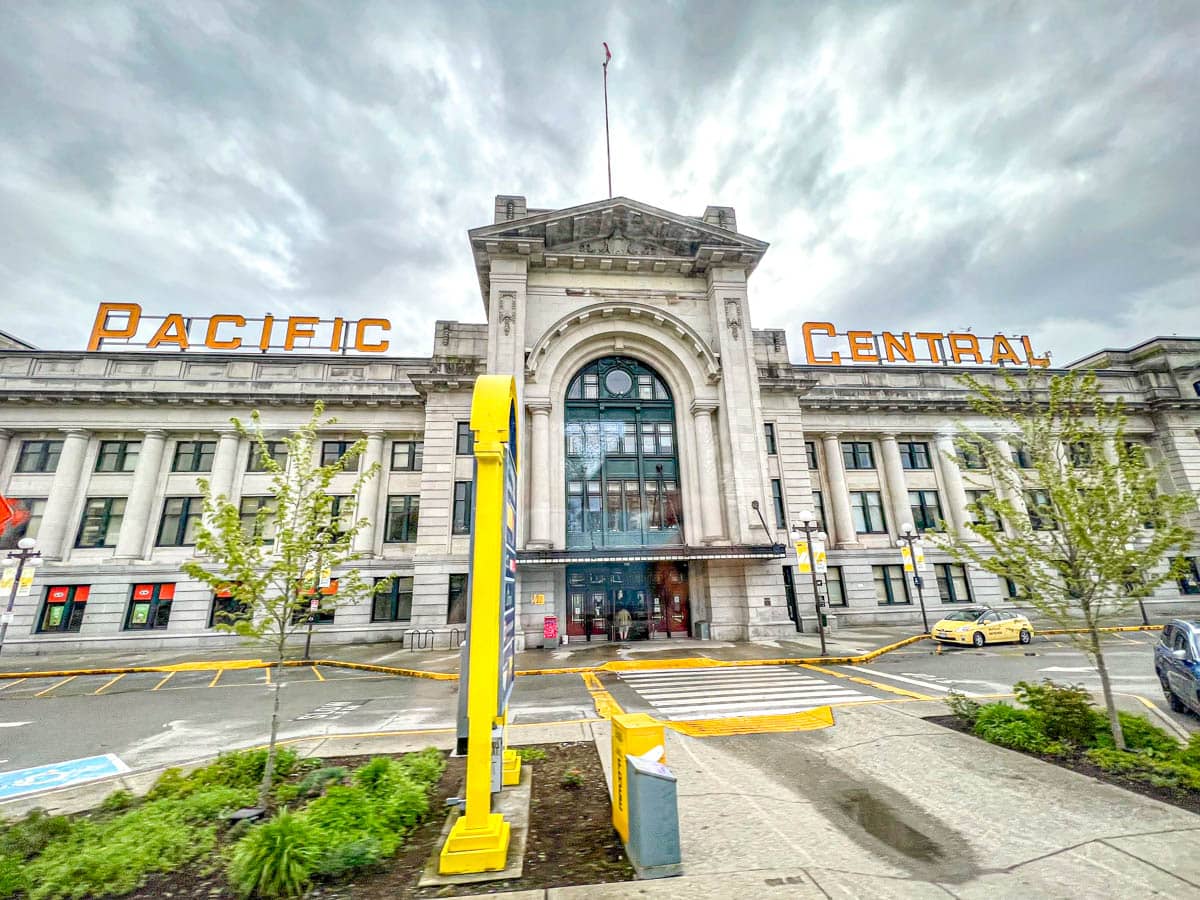 large entrance to pacific central station building in vancouver with grey cloudy sky above.